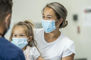 Mother and daughter getting flu shot