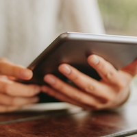 two hands holding a tablet