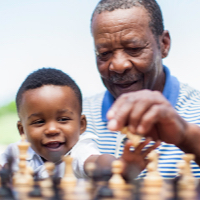 man and child playing chess
