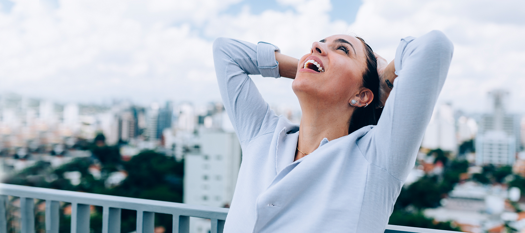 woman smiling and looking up at the sky
