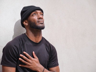 man with hand to chest